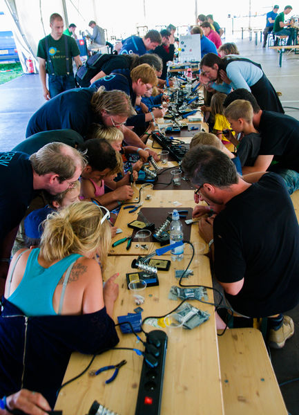 File:Happy kids 2 soldering at OHM2013.jpg
