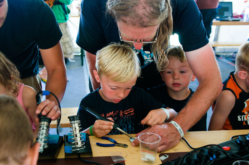 File:Happy kids soldering at OHM2013.jpg